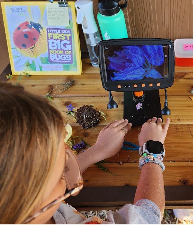 Girl using a microscope at Kids Cultivate